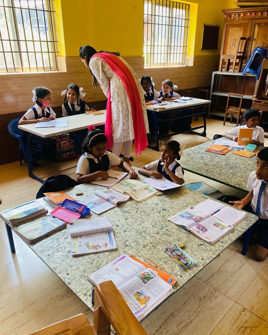 Teacher helping students with studies